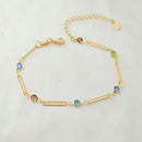 Pulseira de haster cilindricas vazadas com zircônias coloridas, banhada a ouro, medindo 25cm com extensor.